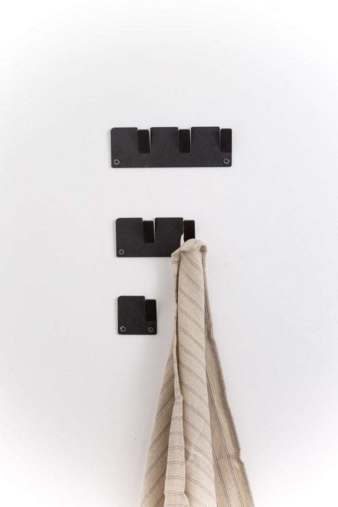 Three Alfa Wall Hooks Set - Various Colours by Garcia Home providing organization with a towel hanging on them.