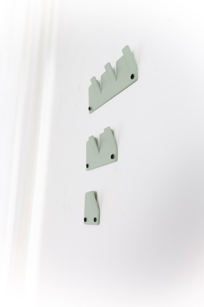 A white Alfa Wall Hooks Set adorned with three green metal hooks, perfect for organization by Garcia Home.