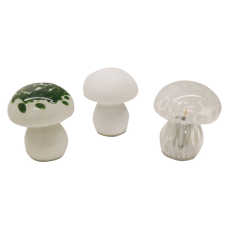 Three mushroom lamps together: green speckled, plain white and clear swirled glass