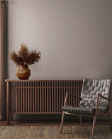A Seagrass Stem Brown Mauve adorned with Artificial Flora plants and greenery sits in front of a floral-styled radiator.
