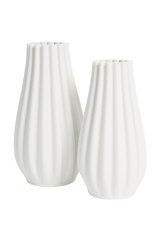 Small and large white Steffi vases nested together on a white background