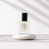 A bottle of GYPSY - inspired by Gypsy Water perfume by The Perfume Oil Company sitting on top of a white stone.