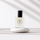 A designer fragrance gift, CALYPSO perfume, inspired by Mango Skin (Vilhelm Parfumerie), sitting on top of a white stone.