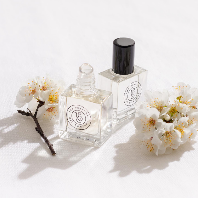 Two small bottles of CALYPSO, inspired by Mango Skin (Vilhelm Parfumerie), by The Perfume Oil Company, on a white surface.