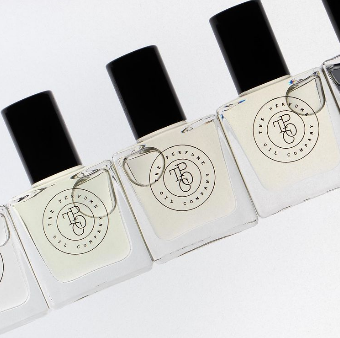 Five bottles of CALYPSO fragrance, inspired by Mango Skin (Vilhelm Parfumerie), are lined up on a white surface, all from The Perfume Oil Company.