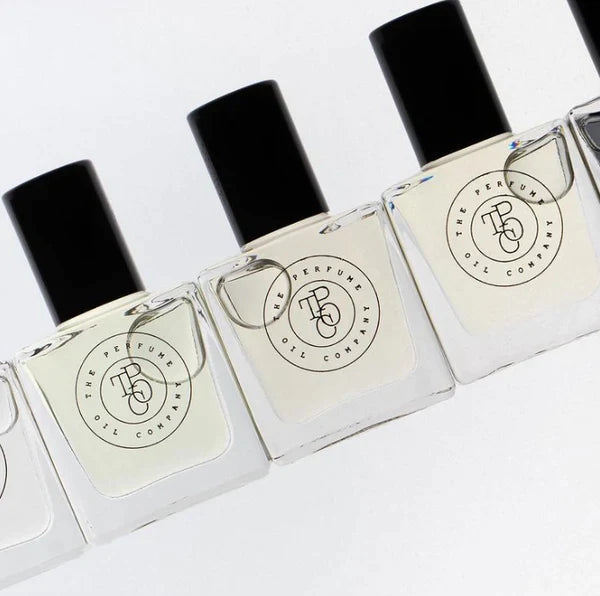 Five bottles of CALYPSO, inspired by Mango Skin (Vilhelm Parfumerie), are lined up on a white surface.