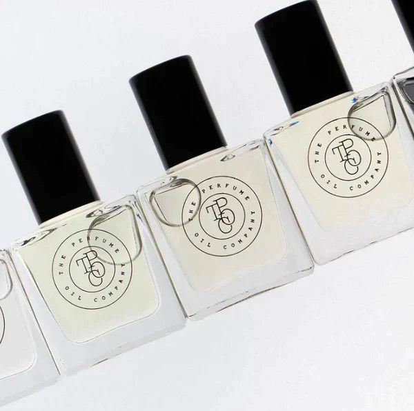 Five bottles of CALYPSO, inspired by Mango Skin (Vilhelm Parfumerie), are lined up on a white surface.
