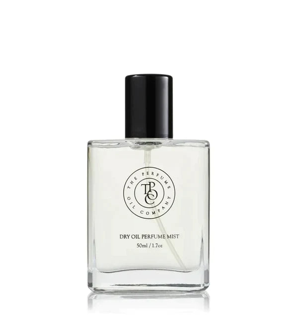 Tall dry oil perfume mist bottle with a black cap, on a plain background