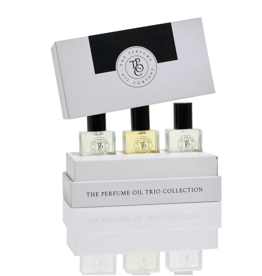 Trio collection gift box with the lid lifted and three roll-on perfume oil bottles in front