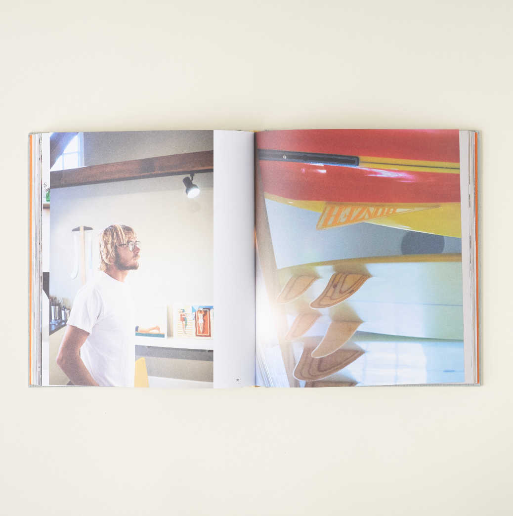 Surf Shacks book styled on a shelf with home decor
