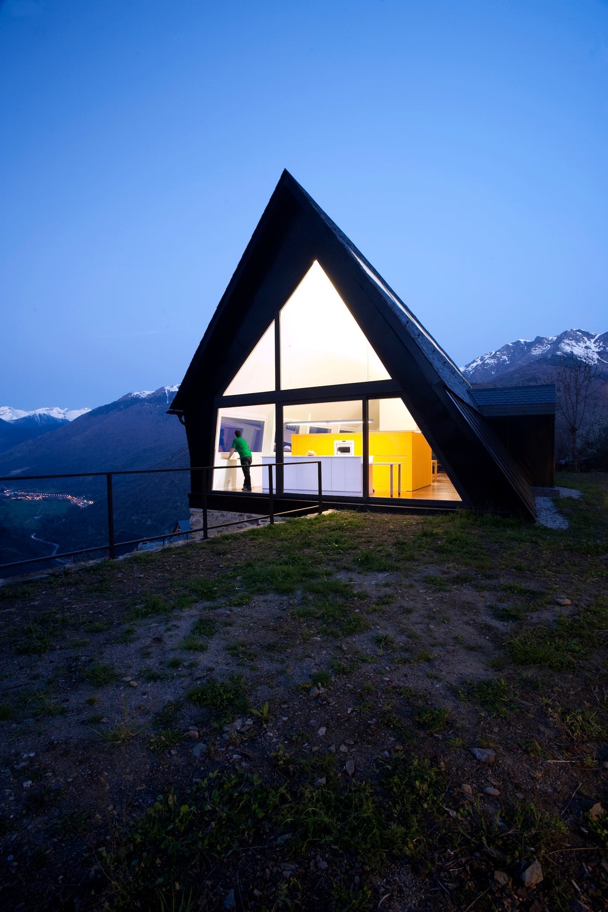 Rock the Shack page spread showing a mountain retreat at dusk