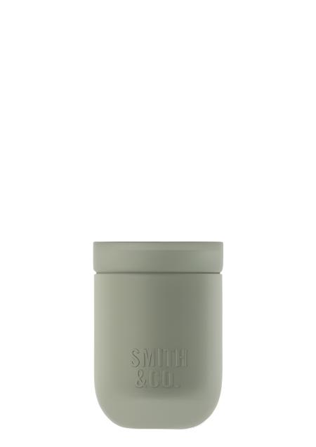 Smith and Co sage green ceramic candle with its lid on, on a plain background