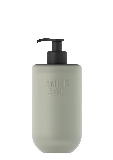 Smith & Co. Amber & Freesia Hand & Body Lotion in a sage green glass bottle with a black pump on white