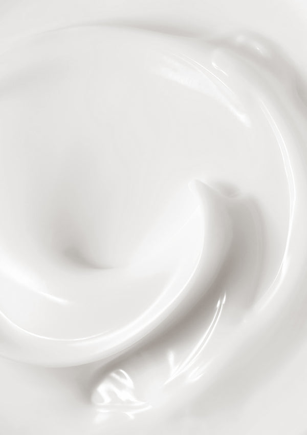 Close view of the white lotion swirled to show its texture