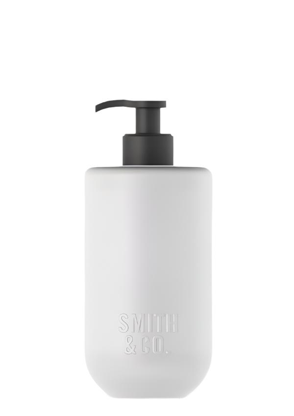 Smith & Co. Tonka & White Musk Hand & Body Wash in a white glass bottle with a black pump on white