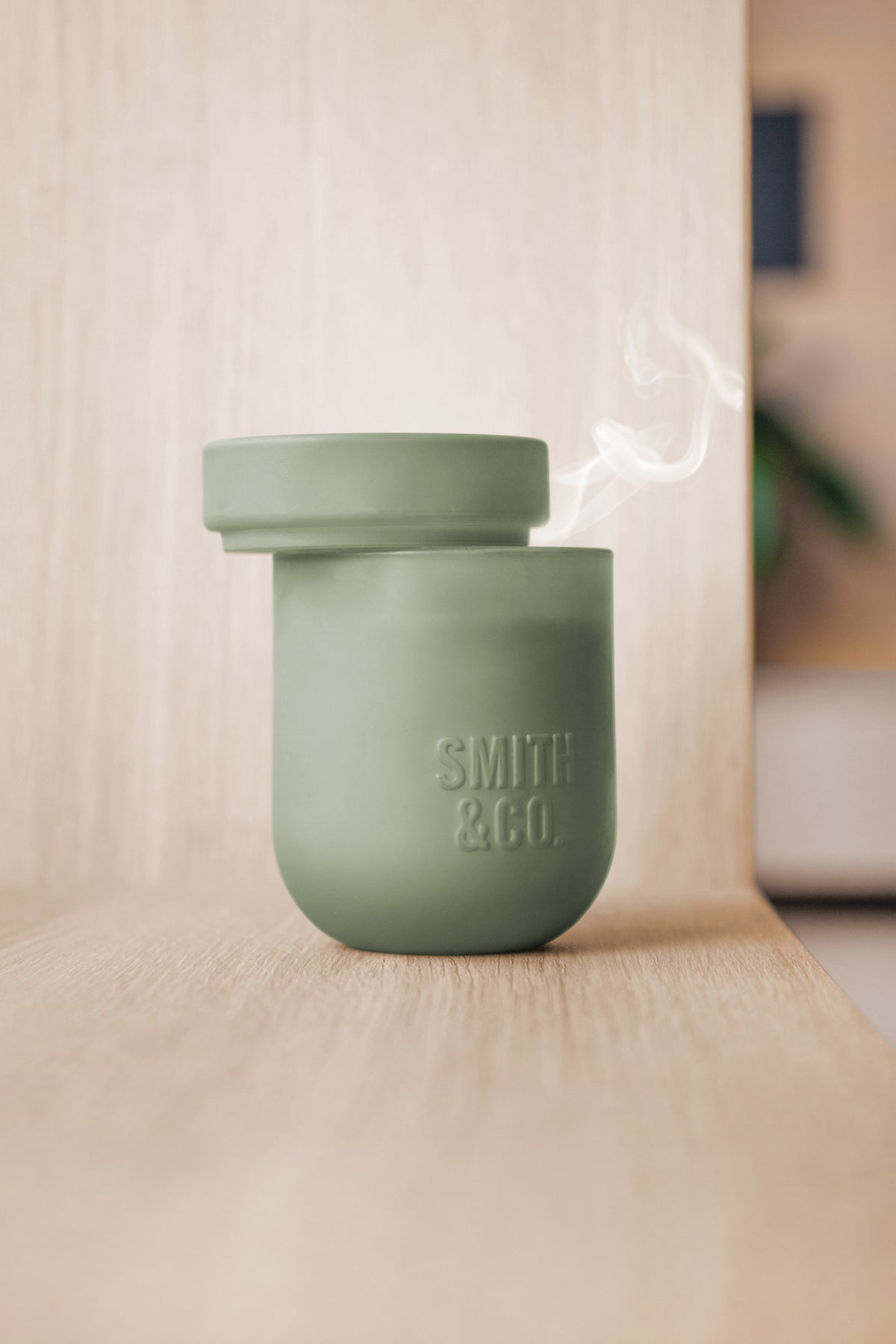 Smith and Co candle with a wisp of smoke rising after being put out