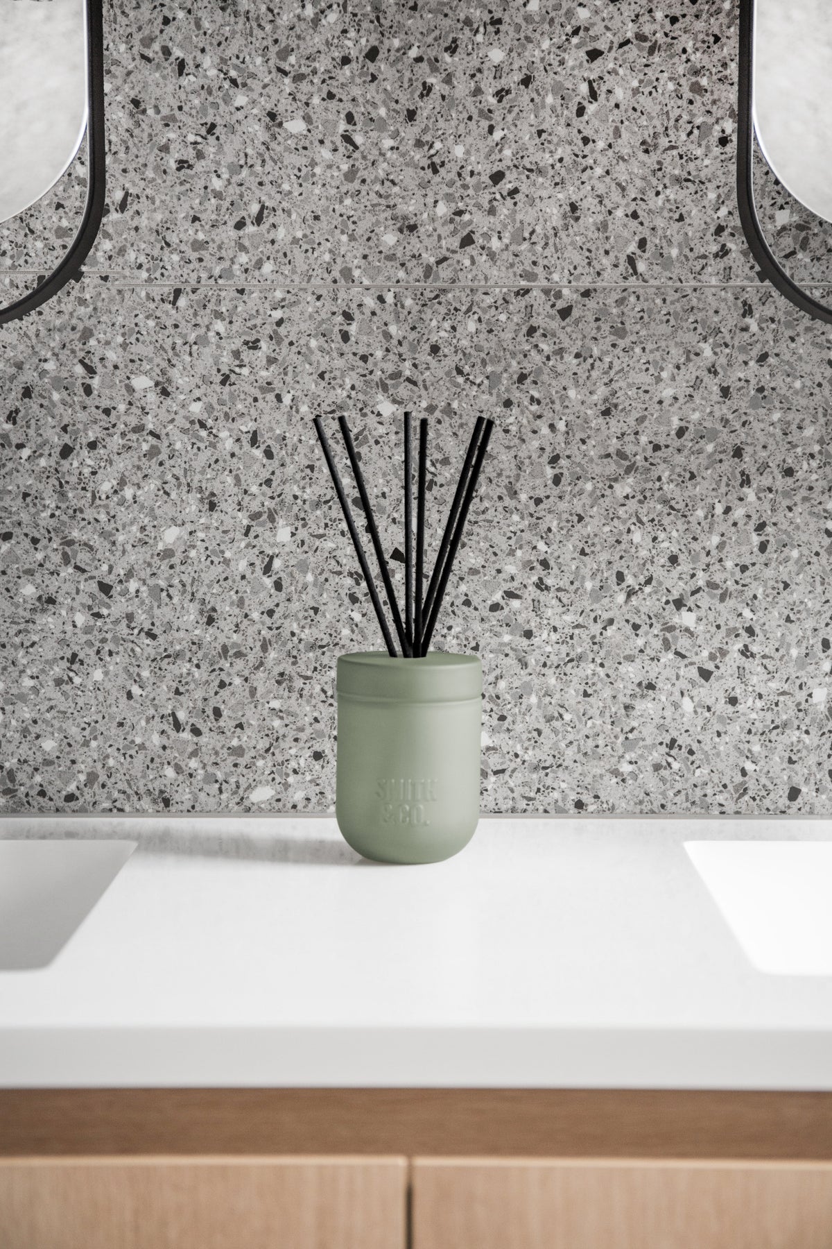 Smith and Co reed diffuser on a white bathroom vanity against a terrazzo splashback