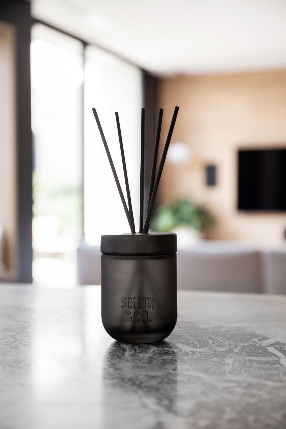 Smith & Co. diffuser on a stone bench in a modern open-plan interior