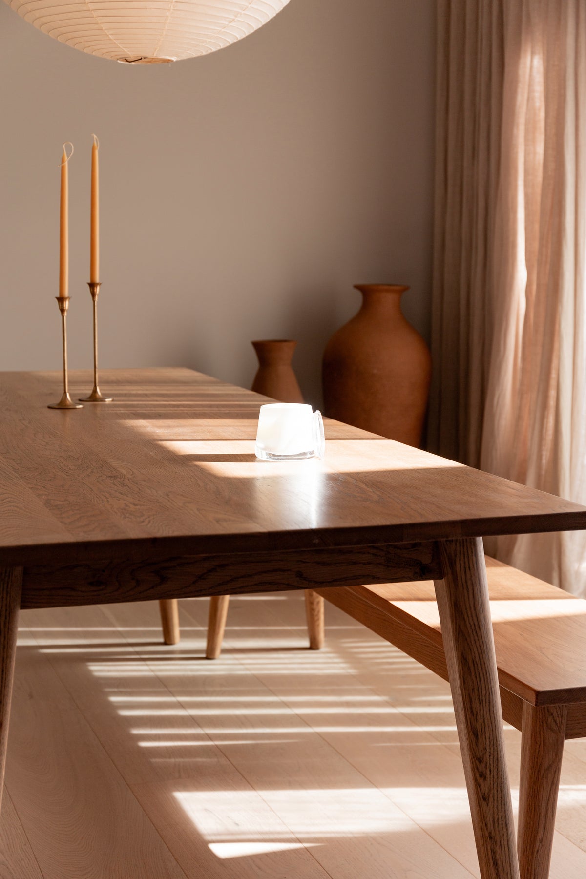 Therapy candle on a dining table beside a tall candlestick