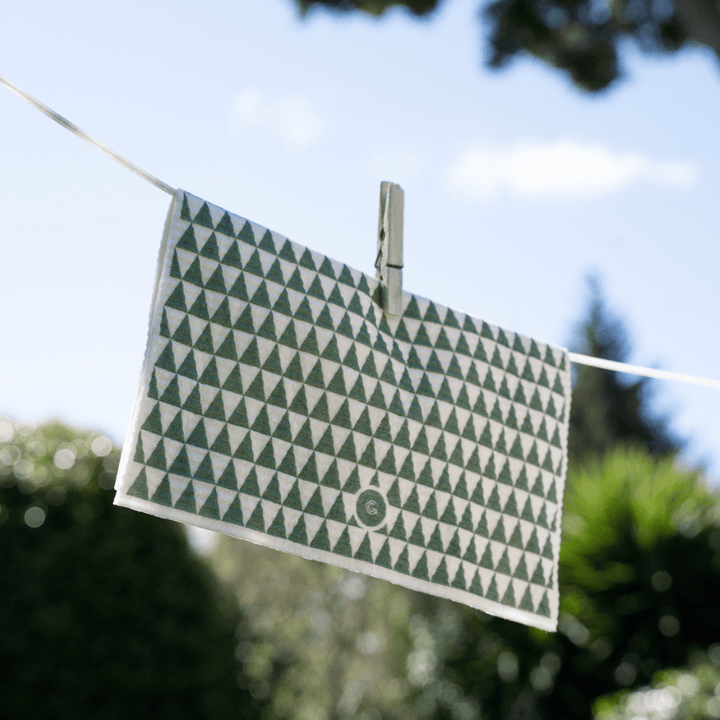 A Good Change ECO CLOTH - LARGE (2-PACK) towel hanging on a clothes line.