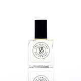 A bottle of CALYPSO perfume, inspired by Mango Skin (Vilhelm Parfumerie), sitting on a white surface.