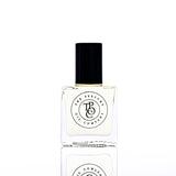 A bottle of CALYPSO perfume, inspired by Mango Skin (Vilhelm Parfumerie), sitting on a white surface.