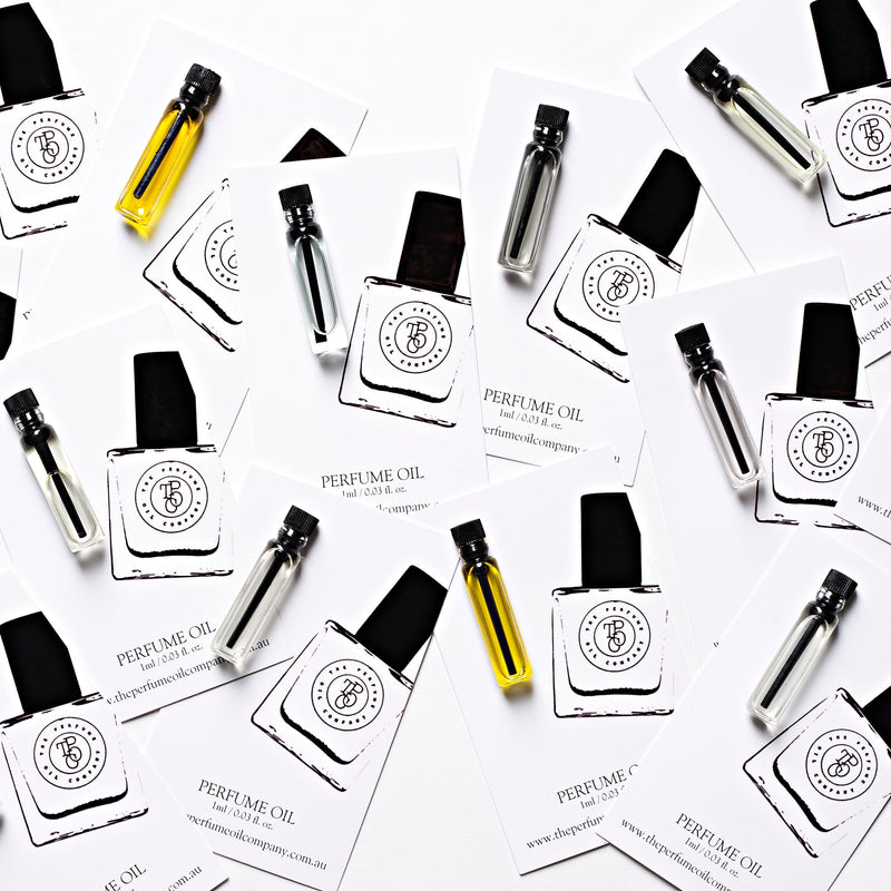 A set of CALYPSO inspired by Mango Skin business cards with a bottle of oil from The Perfume Oil Company on them.
