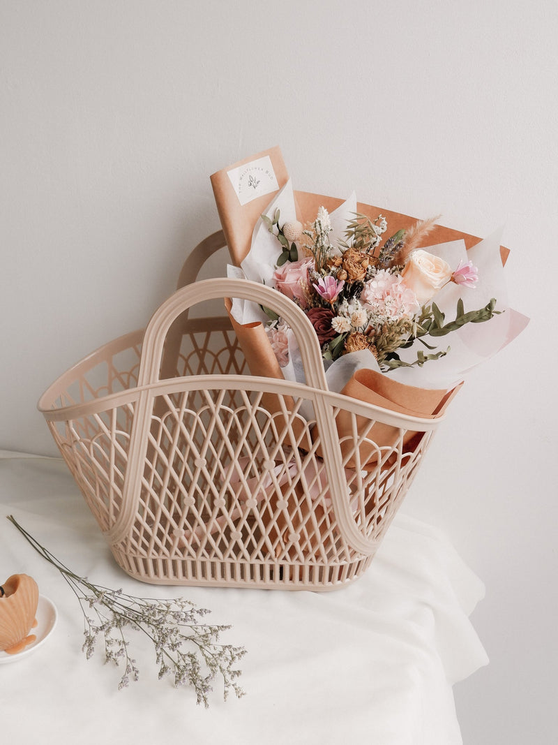 A Sun Jellies Betty Basket filled with a recyclable bouquet of flowers.