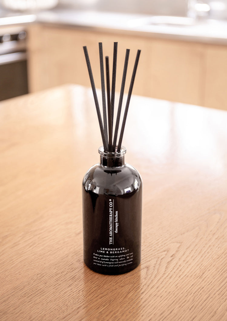 Black Therapy Kitchen Lemongrass, Lime & Bergamot diffuser with reeds on a light oak kitchen table