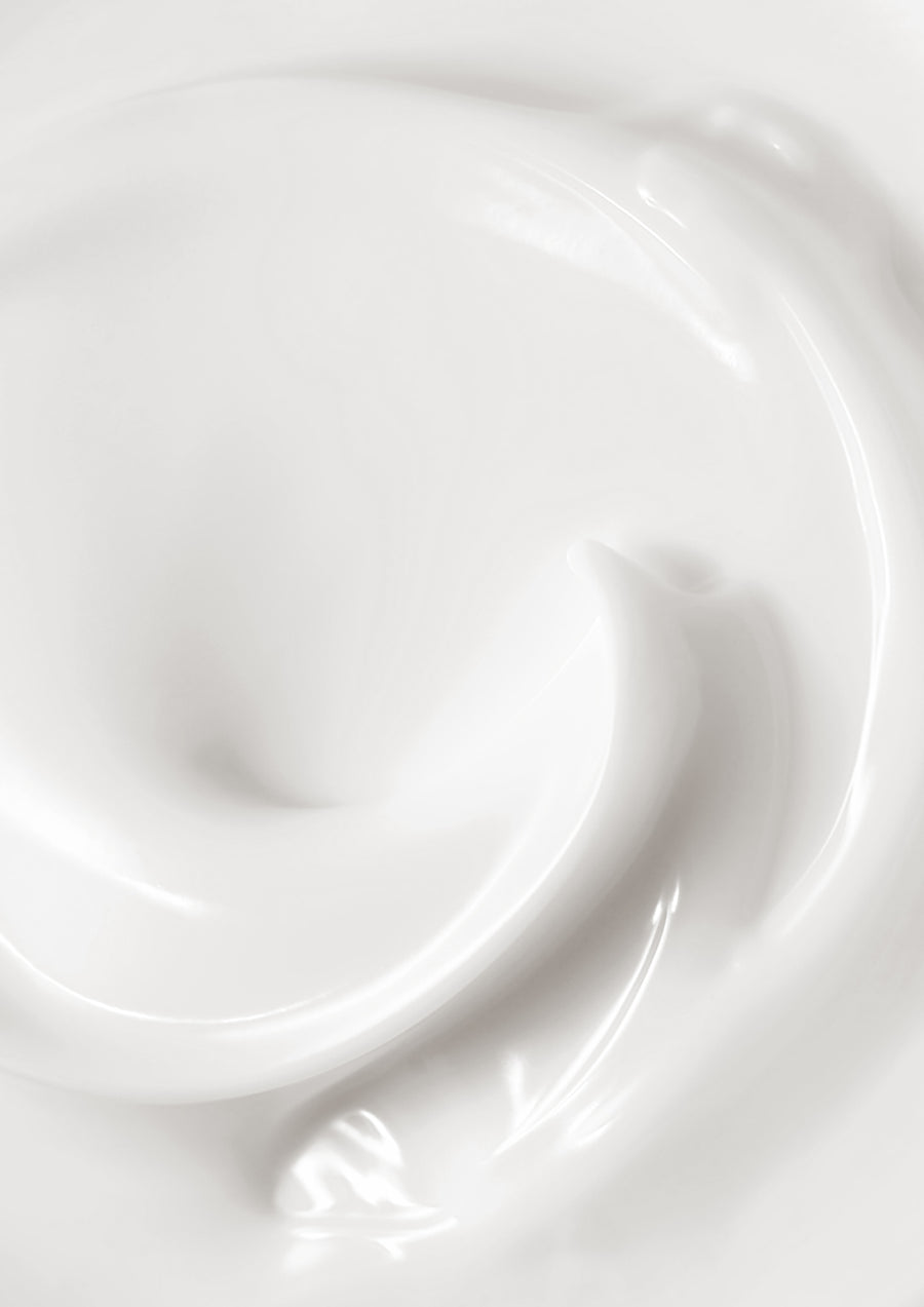 Close up of glossy white lotion swirled into a spiral