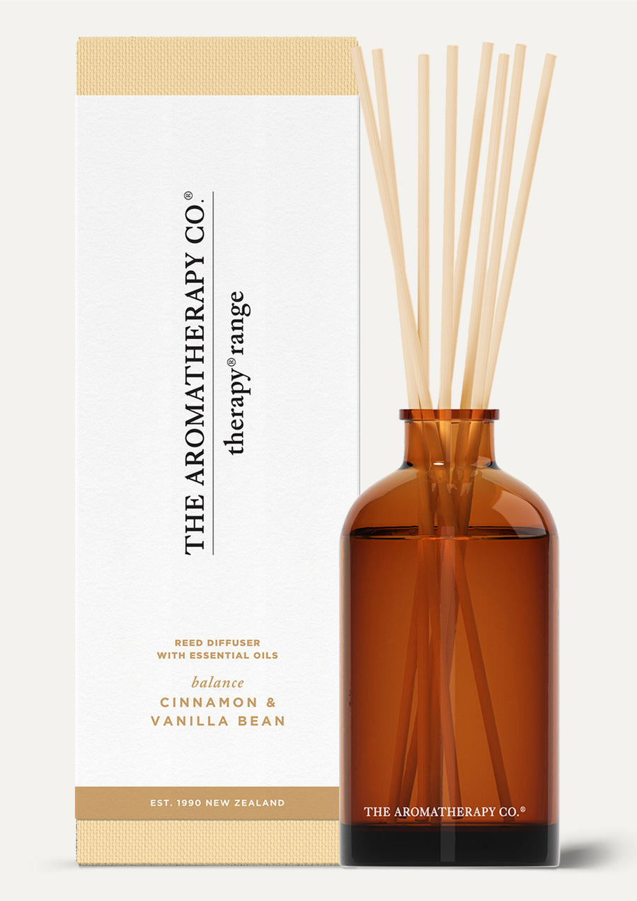 Therapy Balance diffuser with natural reeds and its white and tan box on a light background