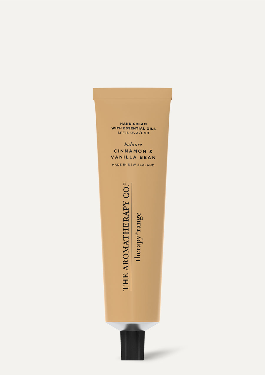 Therapy Cinnamon & Vanilla Bean hand cream in a caramel tube on a pale background