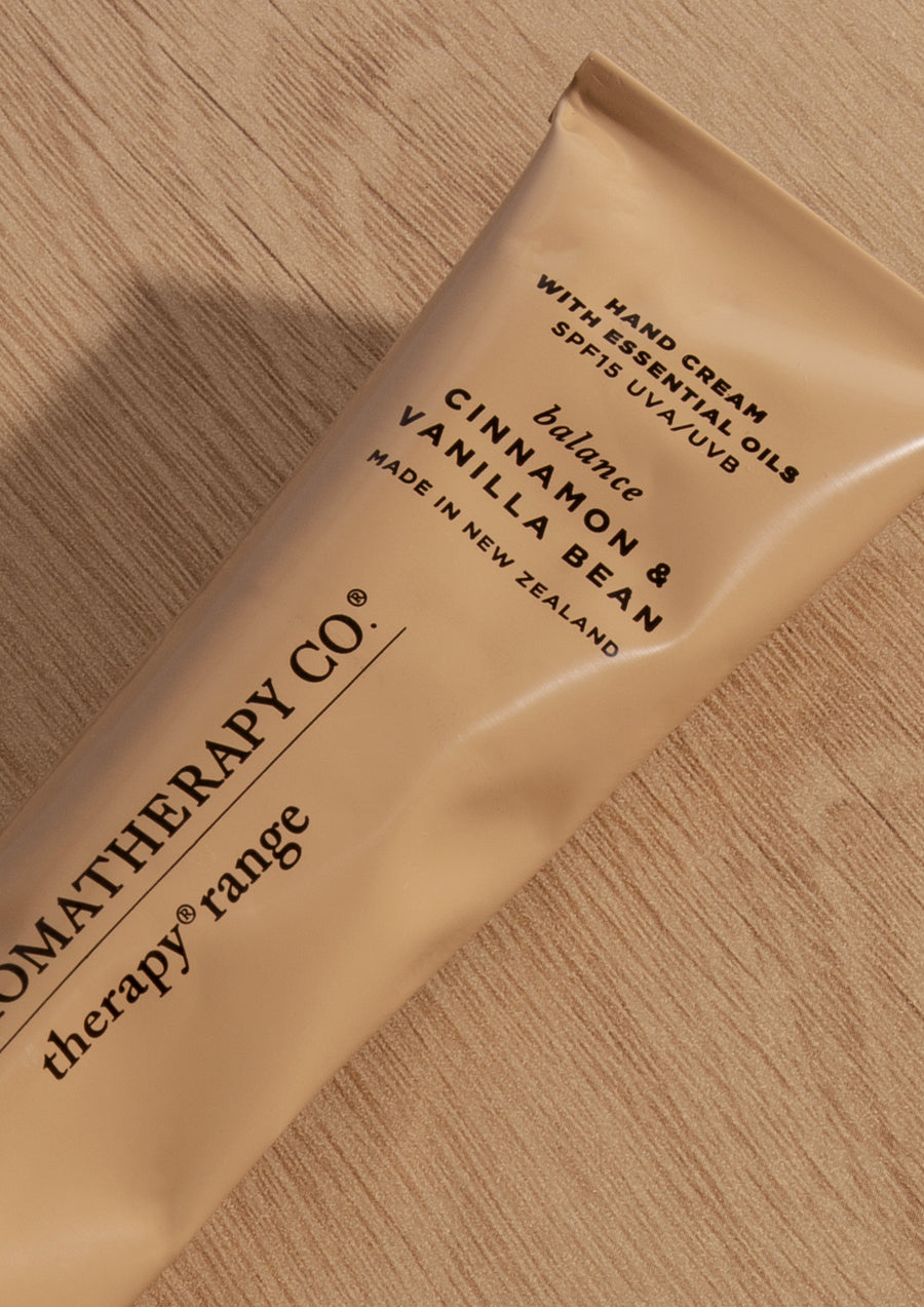 Close crop of the Cinnamon & Vanilla Bean tube label on light oak