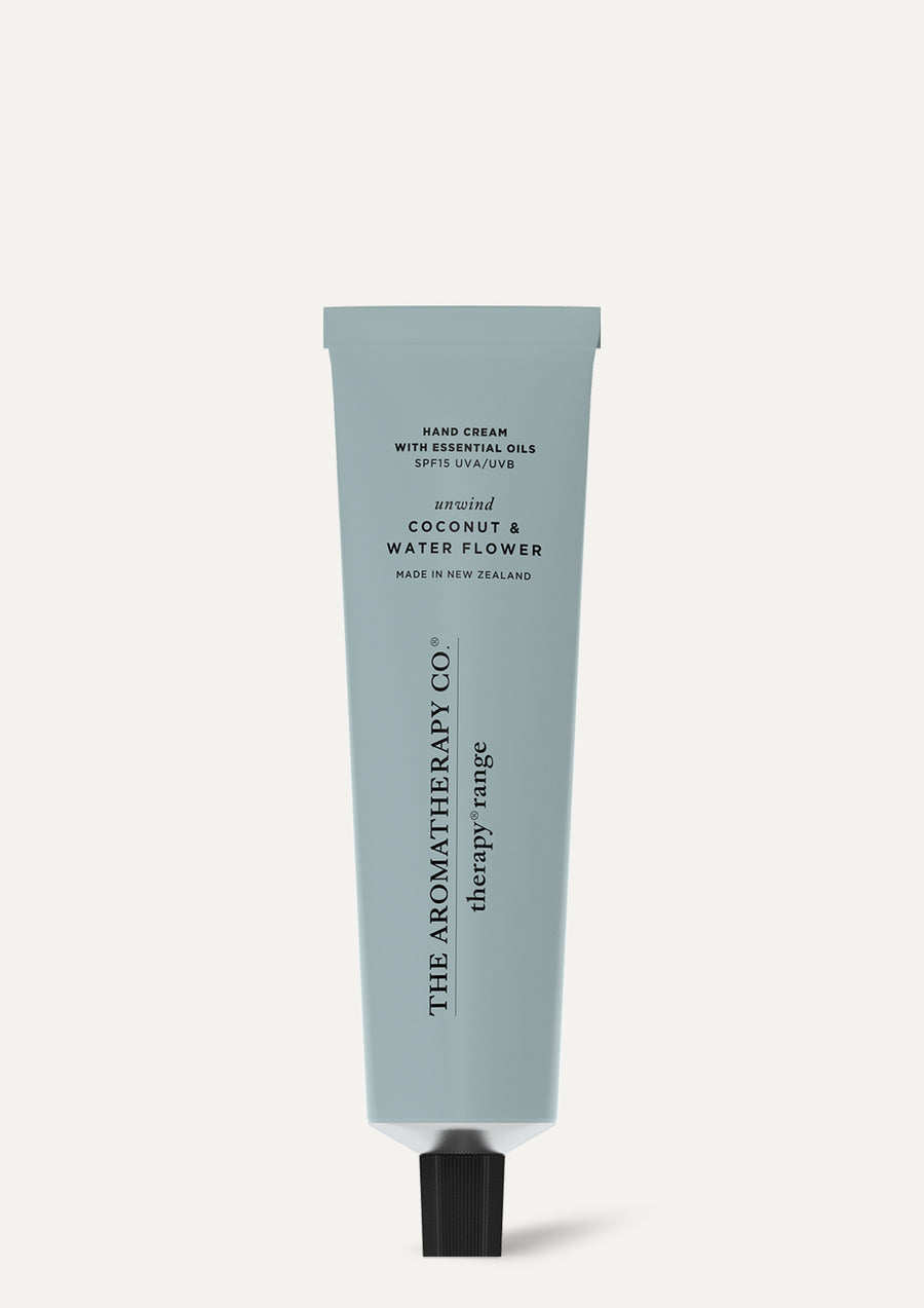 Therapy Coconut & Water Flower hand cream tube standing on a pale background