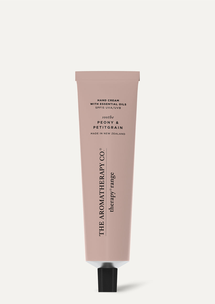 Therapy Peony & Petitgrain hand cream tube standing on a pale grey background