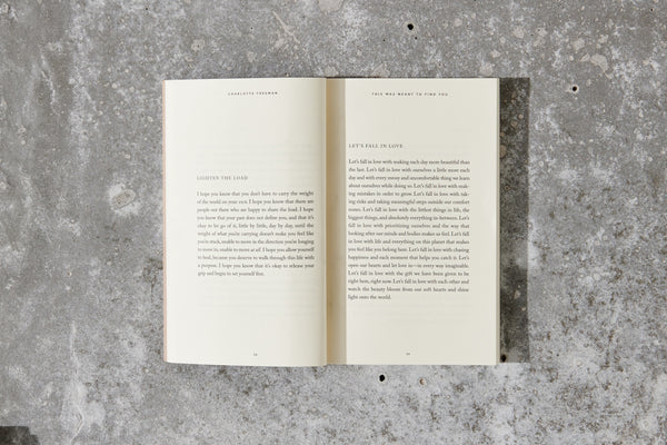 An open Thought Catalog book on a concrete surface.