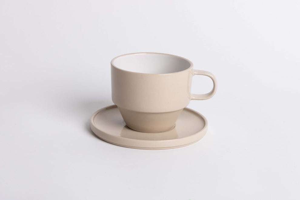 Hudson Mug in cashmere glaze on a matching saucer, on a white background