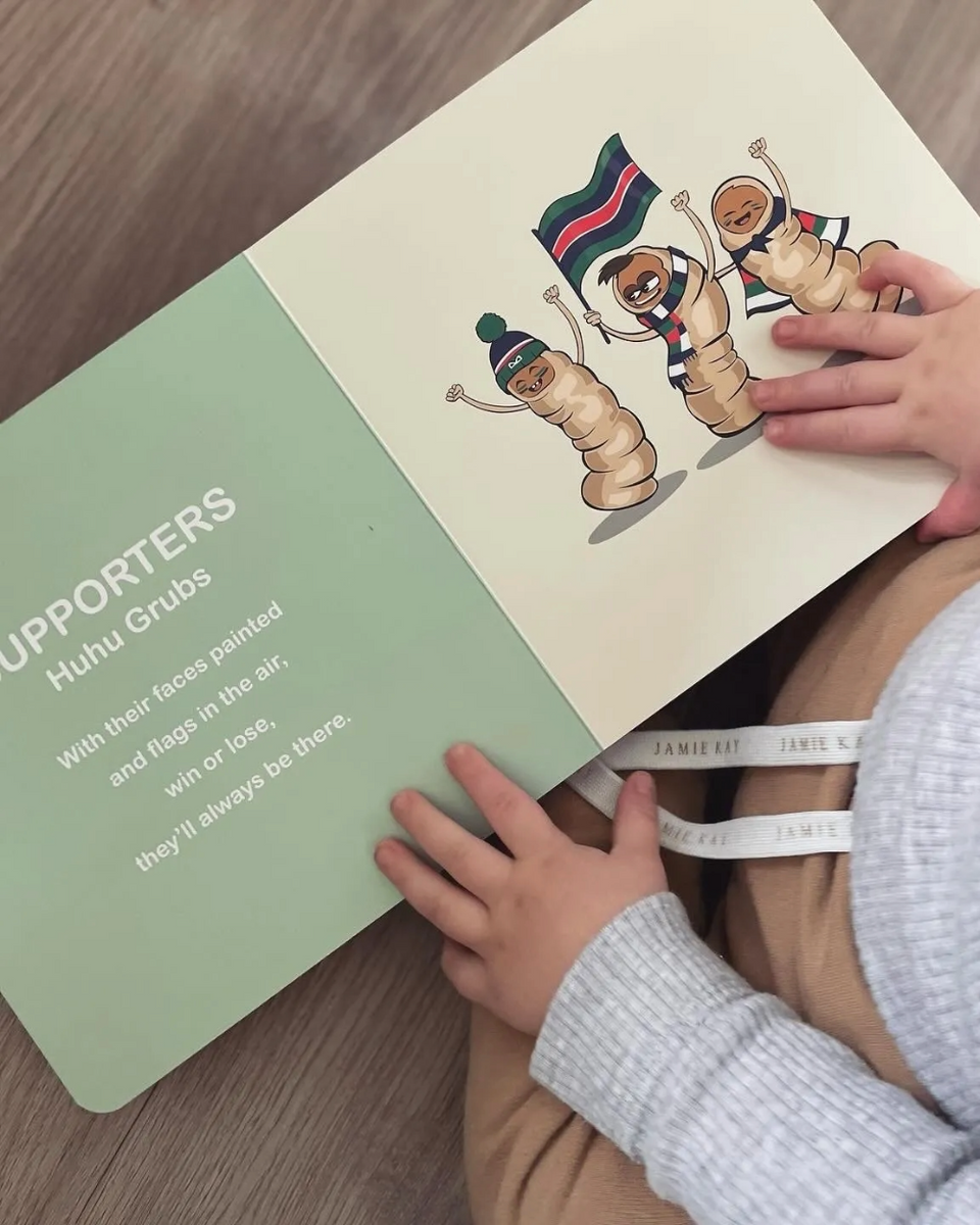 Wild About Footy open at an illustrated page of team supporters