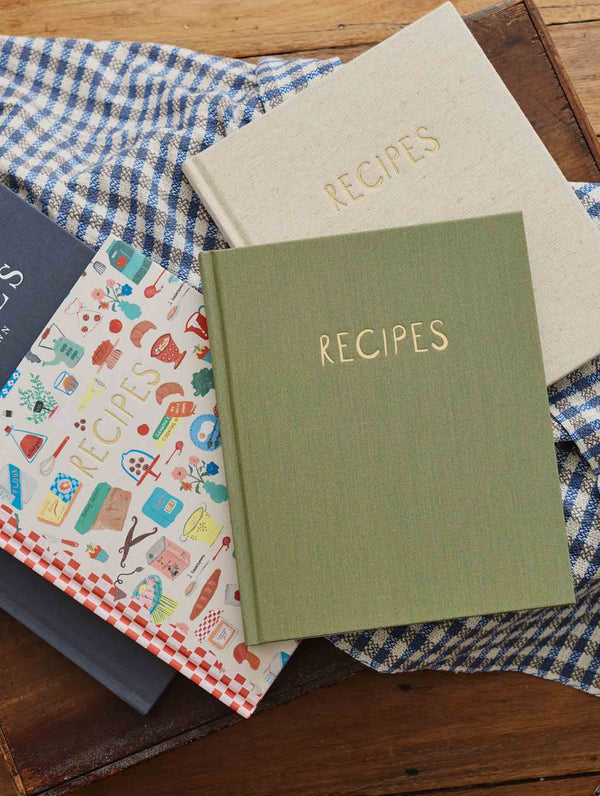 Olive and oatmeal Write To Me recipe journals on blue gingham with the illustrated endpapers