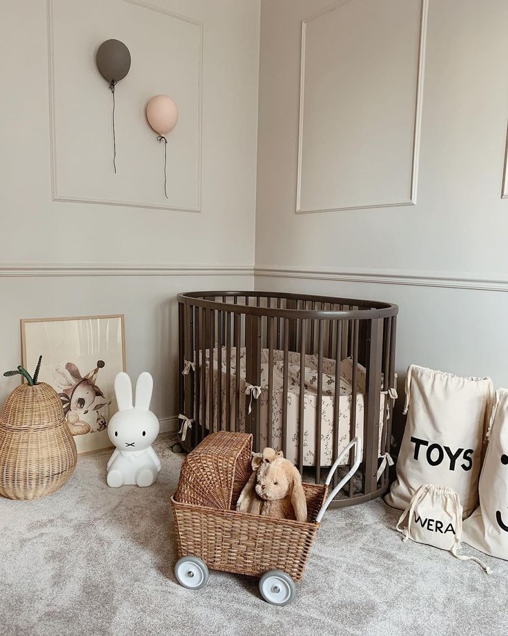 Miffy bunny lamp on a nursery floor beside an oval cot, wicker toy pram and canvas storage bags