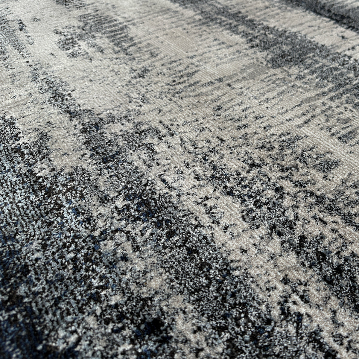 Close view of the low pile with streaked blue, grey and ivory bands