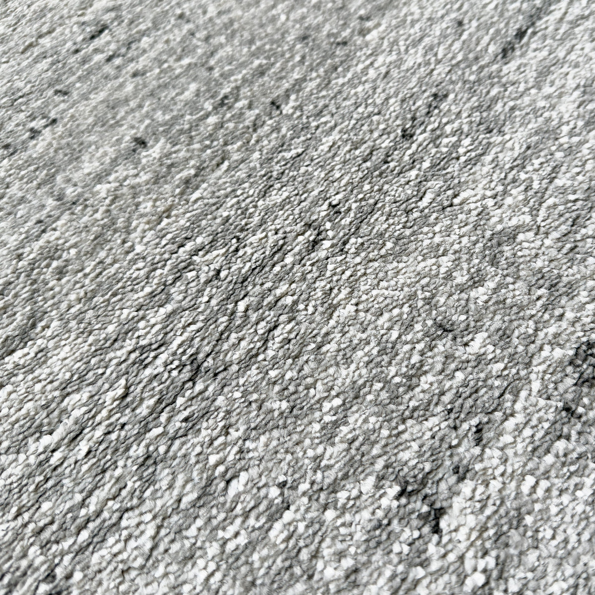 Close view of the heathered pale grey pile
