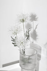 Artificial Alpine Flower in cream styled in glass ribbed vase – tall faux wildflower stem for airy, elegant interiors