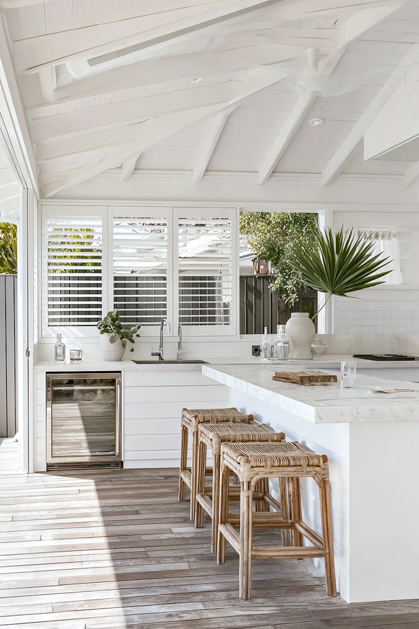 Artificial bluegum eucalyptus bush styled in a bright coastal kitchen with natural textures and white finishes.