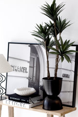 Artificial Dracaena potted plant, 91cm tall with 6 heads, styled in black planter beside Chanel art print