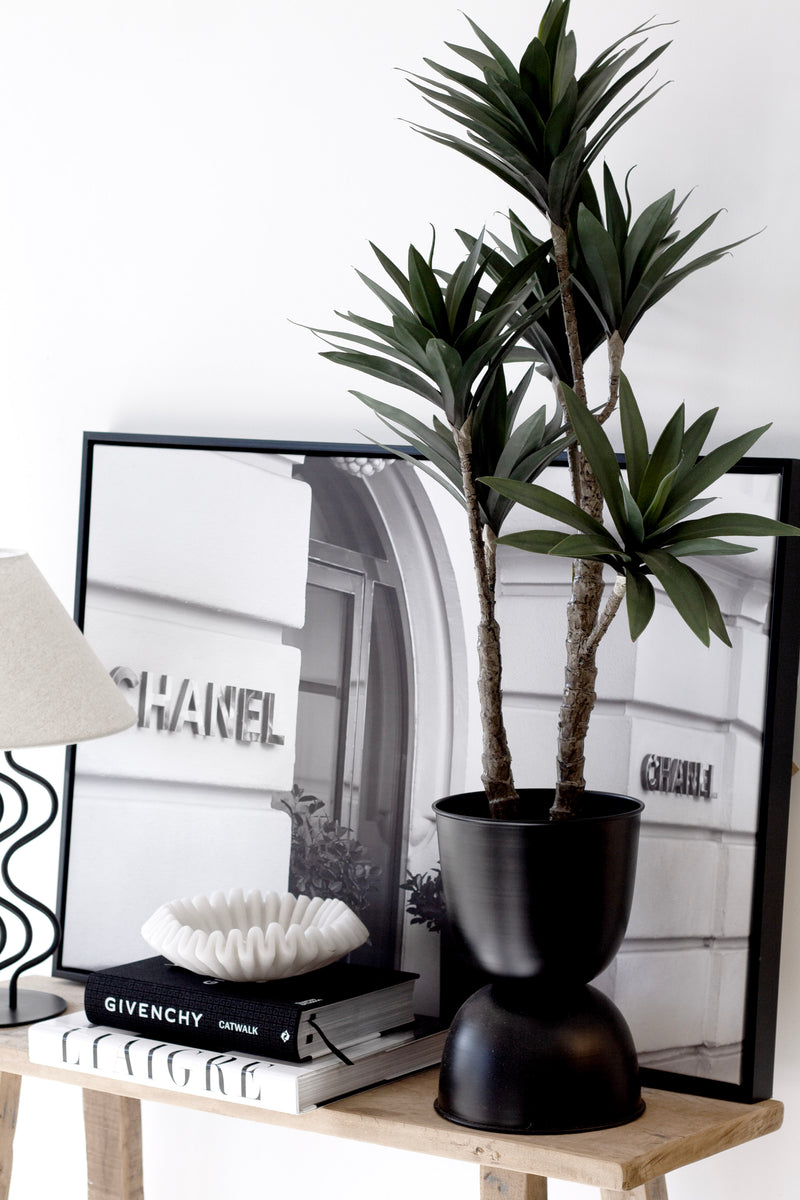 Artificial Dracaena potted plant, 91cm tall with 6 heads, styled in black planter beside Chanel art print
