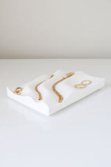 An Utilize Studios Tidal Tray made from recycled plastic, showcasing 3D printed gold jewelry.