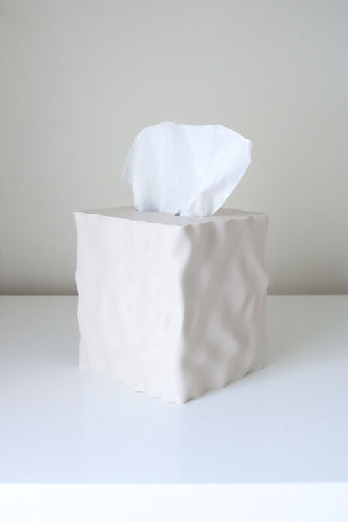 Flow tissue box cover in a pale beige matte finish on a white table
