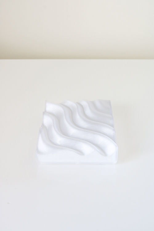 A Ripple Soap Tray, 3D printed using recycled PLA plastic, adorned with a wave pattern, manufactured by Utilize Studios.