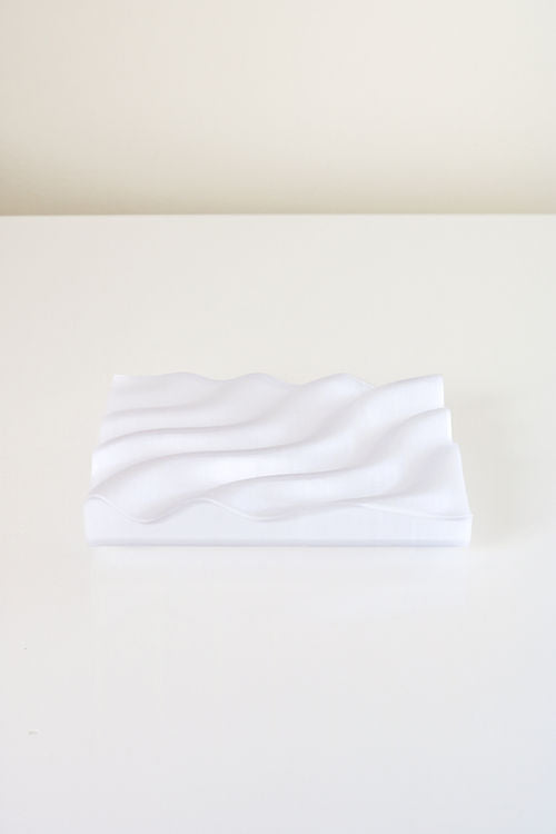 A Ripple Soap Tray made from recycled PLA plastic and featuring a wave pattern, created by Utilize Studios.